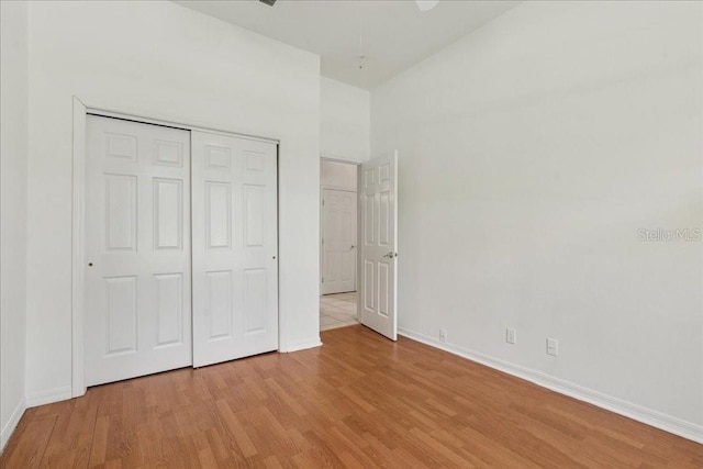49 Ludlow Ln W, Palm Coast, FL 32137 - unfurnished bedroom with light wood finished floors, baseboards, and a closet