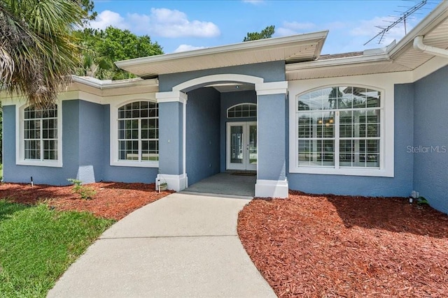 49 Ludlow Ln W, Palm Coast, FL 32137 - property entrance with stucco siding and french doors