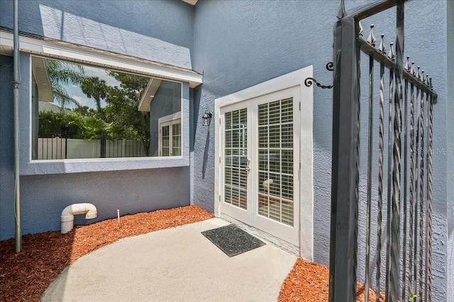 49 Ludlow Ln W, Palm Coast, FL 32137 - view of exterior entry with stucco siding and a patio