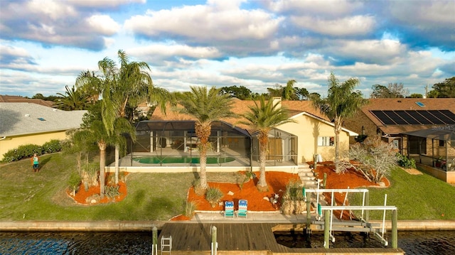29 Cherrytree Ct, Palm Coast, FL 32137 - back of property with a swimming pool, a patio area, boat lift, a lawn, and glass enclosure