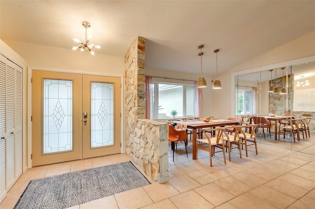 29 Cherrytree Ct, Palm Coast, FL 32137 - foyer featuring lofted ceiling, a chandelier, french doors, and light tile patterned floors