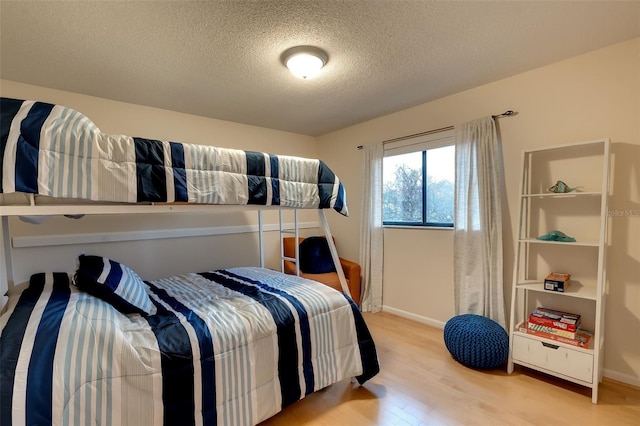 29 Cherrytree Ct, Palm Coast, FL 32137 - bedroom featuring wood finished floors, a textured ceiling, and baseboards