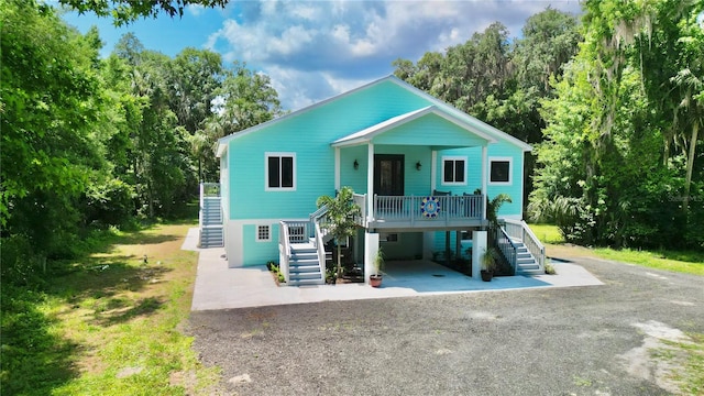 101 Beechers Point Dr, Welaka, FL 32193 - beach home with stairs, driveway, a carport, and a porch