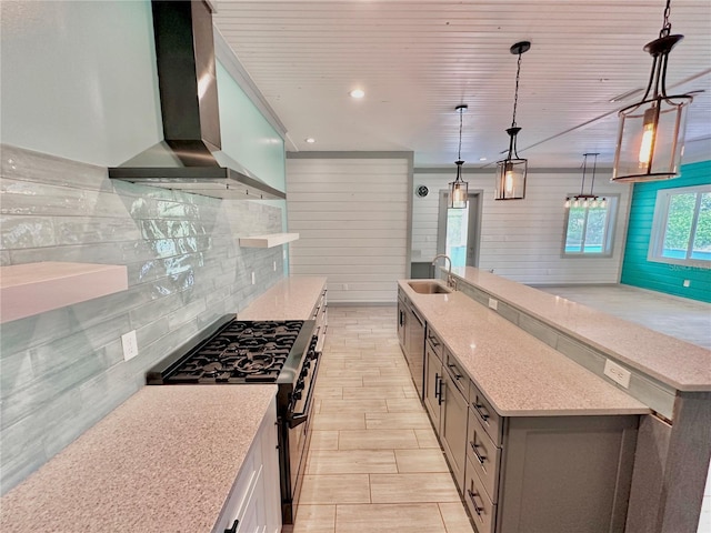 101 Beechers Point Dr, Welaka, FL 32193 - kitchen with wall chimney exhaust hood, range with gas cooktop, a large island, decorative backsplash, and a sink