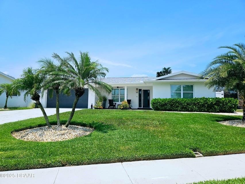 13 Sunrise Ave, Ormond Beach, FL 32176 - ranch-style house featuring a garage, a front yard, and driveway