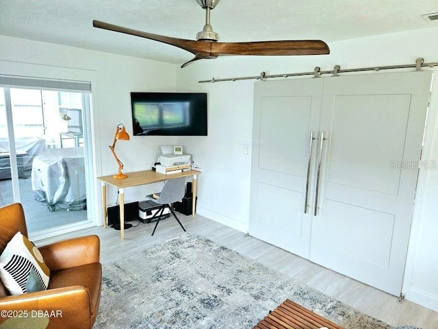 13 Sunrise Ave, Ormond Beach, FL 32176 - office space with light wood-style flooring, baseboards, and a barn door
