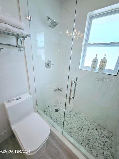 13 Sunrise Ave, Ormond Beach, FL 32176 - full bathroom featuring a shower stall, toilet, and wood finished floors