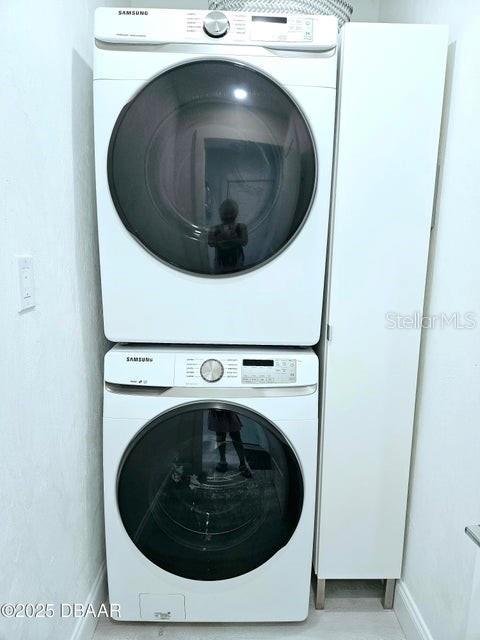 13 Sunrise Ave, Ormond Beach, FL 32176 - laundry area featuring stacked washer / drying machine and baseboards