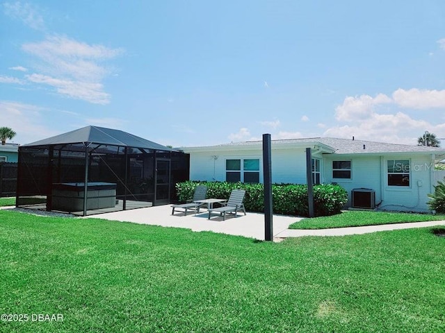 13 Sunrise Ave, Ormond Beach, FL 32176 - rear view of property featuring a hot tub, a patio area, a yard, and glass enclosure
