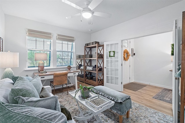 100 Las Casitas Blvd, Palm Coast, FL 32137 - living area featuring an office area, wood finished floors, ceiling fan, baseboards, and french doors