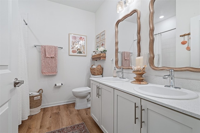 100 Las Casitas Blvd, Palm Coast, FL 32137 - bathroom with double vanity, wood finished floors, toilet, and curtained shower