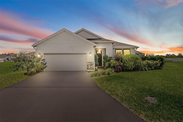 100 Las Casitas Blvd, Palm Coast, FL 32137 - view of front of home featuring a garage, a yard, concrete driveway, and stone siding