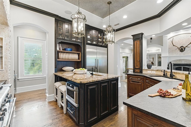 140 Monterey Bay Ln, Green Cove Springs, FL 32043 - kitchen featuring a sink, premium appliances, crown molding, arched walkways, and ornate columns