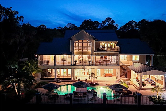 140 Monterey Bay Ln, Green Cove Springs, FL 32043 - back of house with a balcony, a fenced backyard, an outdoor hot tub, and a patio