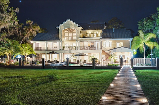 140 Monterey Bay Ln, Green Cove Springs, FL 32043 - back of house at night featuring a balcony and metal roof
