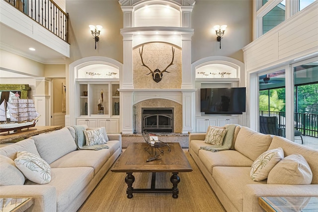 140 Monterey Bay Ln, Green Cove Springs, FL 32043 - living area featuring a towering ceiling, built in features, a fireplace with raised hearth, and recessed lighting