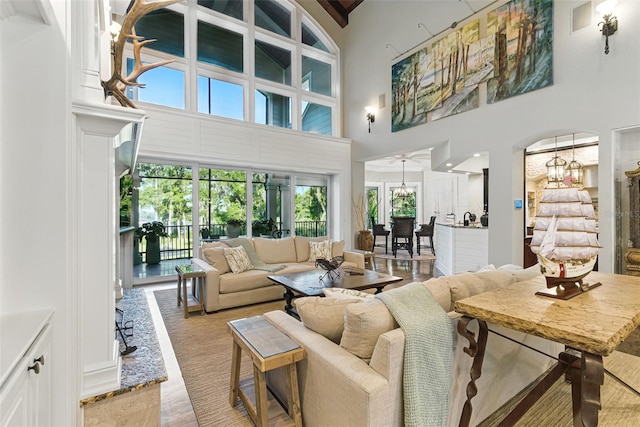 140 Monterey Bay Ln, Green Cove Springs, FL 32043 - living area with a towering ceiling, a chandelier, and beamed ceiling