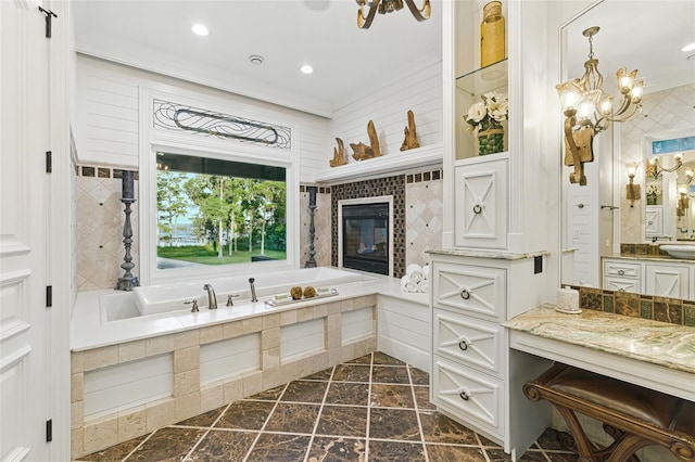 140 Monterey Bay Ln, Green Cove Springs, FL 32043 - bathroom with a garden tub, stone finish flooring, vanity, a chandelier, and recessed lighting