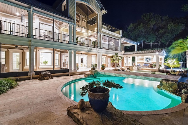 140 Monterey Bay Ln, Green Cove Springs, FL 32043 - pool at night featuring a patio, an outdoor pool, and french doors