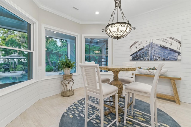 140 Monterey Bay Ln, Green Cove Springs, FL 32043 - dining area with wood finished floors, a chandelier, crown molding, wooden walls, and recessed lighting