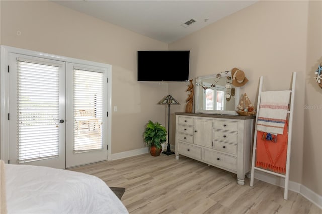 200 Bella Harbor Ct Unit 113, Palm Coast, FL 32137 - bedroom with light wood finished floors, access to exterior, lofted ceiling, french doors, and baseboards
