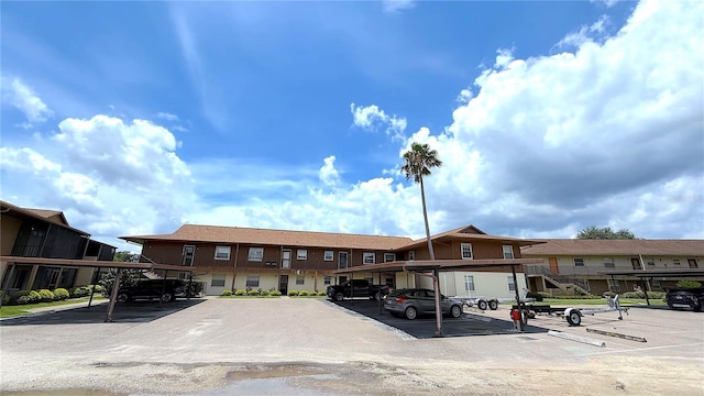1640 Juno Trl Unit 202E, Astor, FL 32102 - view of property with covered and uncovered parking