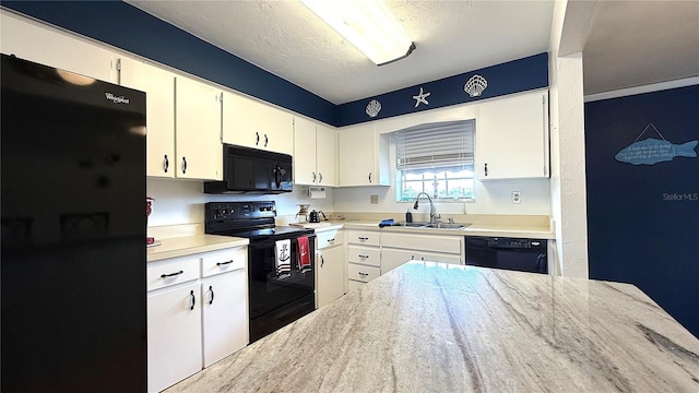 1640 Juno Trl Unit 202E, Astor, FL 32102 - kitchen featuring black appliances, a sink, white cabinets, and a textured ceiling