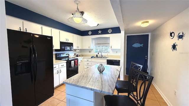 1640 Juno Trl Unit 202E, Astor, FL 32102 - kitchen with black appliances, light tile patterned floors, a breakfast bar area, a sink, and a center island
