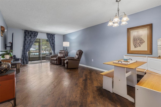 640 N Nova Rd Unit 117, Ormond Beach, FL 32174 - living area with dark wood-style floors, a chandelier, a textured ceiling, and baseboards