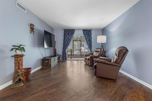 640 N Nova Rd Unit 117, Ormond Beach, FL 32174 - sitting room featuring wood finished floors, a textured ceiling, and baseboards