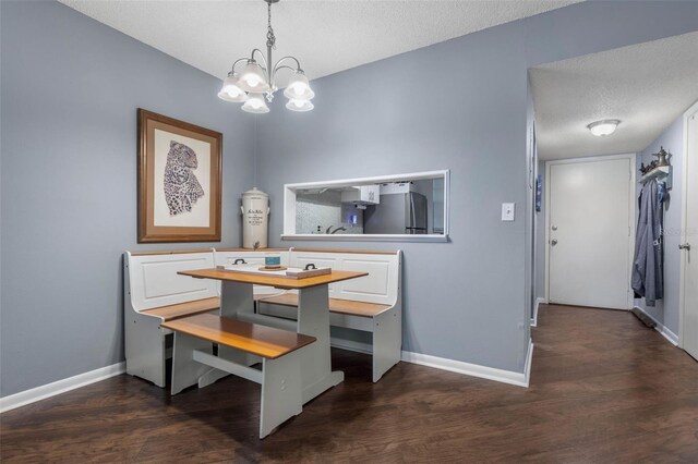 640 N Nova Rd Unit 117, Ormond Beach, FL 32174 - dining area featuring a chandelier, baseboards, dark wood-style flooring, and a textured ceiling