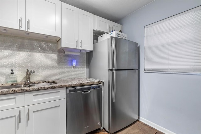 640 N Nova Rd Unit 117, Ormond Beach, FL 32174 - kitchen with stainless steel appliances, a sink, white cabinets, backsplash, and light stone countertops