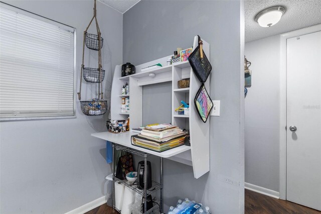640 N Nova Rd Unit 117, Ormond Beach, FL 32174 - home office featuring baseboards, a textured ceiling, and dark wood-style flooring