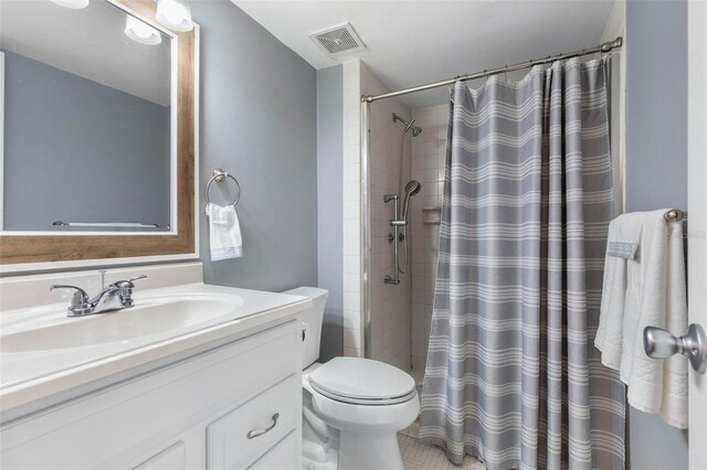 640 N Nova Rd Unit 117, Ormond Beach, FL 32174 - bathroom featuring toilet, vanity, and a shower with curtain