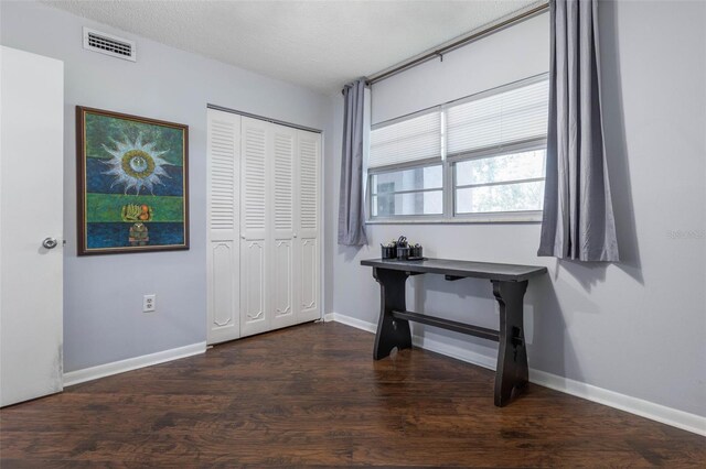 640 N Nova Rd Unit 117, Ormond Beach, FL 32174 - unfurnished bedroom with wood finished floors, baseboards, and a closet