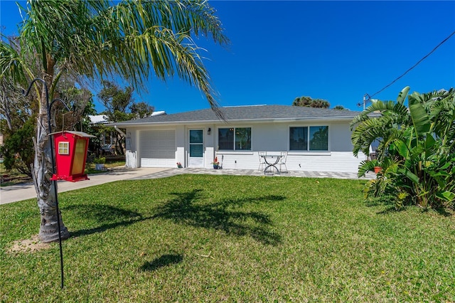 129 Dundee Rd, Daytona Beach, FL 32118 - ranch-style home with an attached garage, driveway, and a front lawn
