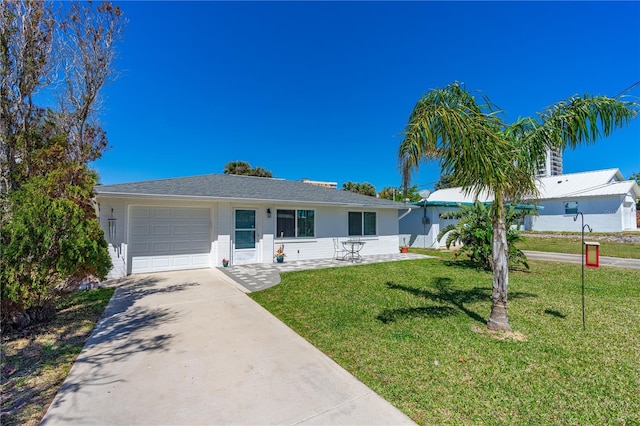 129 Dundee Rd, Daytona Beach, FL 32118 - ranch-style home featuring an attached garage, a front lawn, driveway, and stucco siding