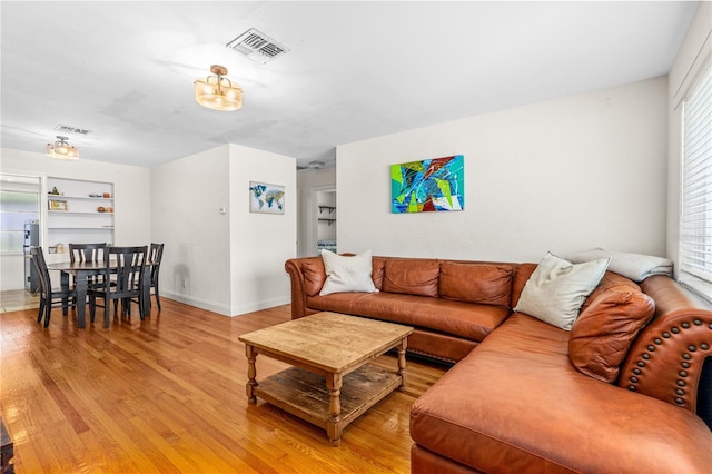 129 Dundee Rd, Daytona Beach, FL 32118 - living area with light wood finished floors, built in features, and baseboards