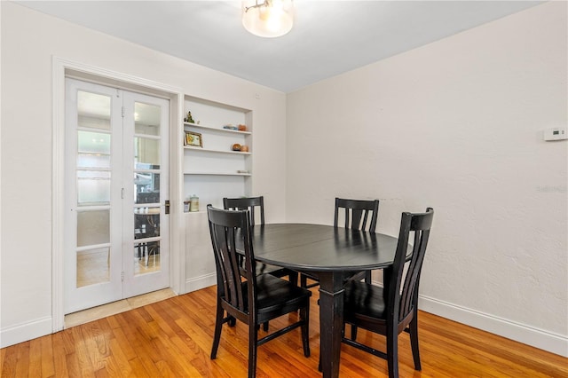 129 Dundee Rd, Daytona Beach, FL 32118 - dining space featuring french doors, light wood finished floors, baseboards, and built in features