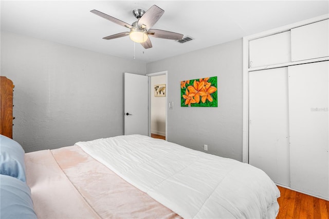 129 Dundee Rd, Daytona Beach, FL 32118 - bedroom with wood finished floors, a closet, and a ceiling fan