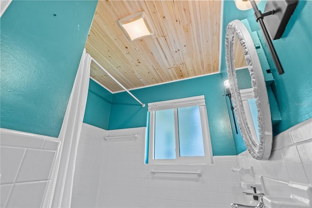 129 Dundee Rd, Daytona Beach, FL 32118 - bathroom with wood ceiling, curtained shower, and wainscoting