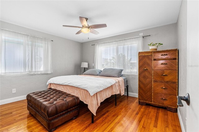129 Dundee Rd, Daytona Beach, FL 32118 - bedroom featuring baseboards, wood finished floors, and a ceiling fan