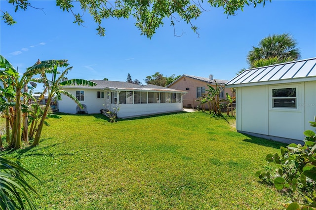 129 Dundee Rd, Daytona Beach, FL 32118 - view of yard with a sunroom and an outbuilding