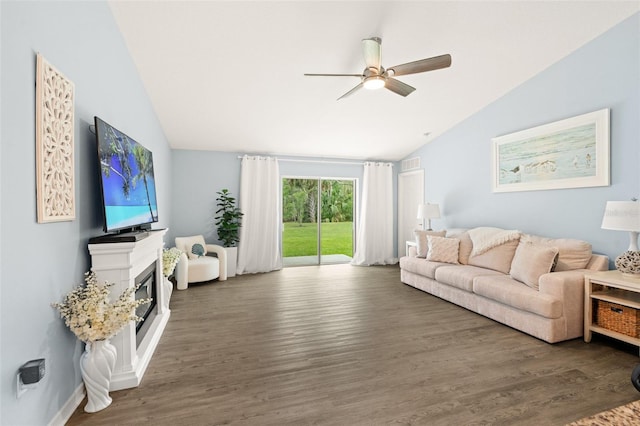 217 Birchwood Dr, Palm Coast, FL 32137 - living room featuring vaulted ceiling, ceiling fan, wood finished floors, and a glass covered fireplace