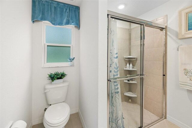 217 Birchwood Dr, Palm Coast, FL 32137 - bathroom with toilet, a stall shower, baseboards, and plenty of natural light
