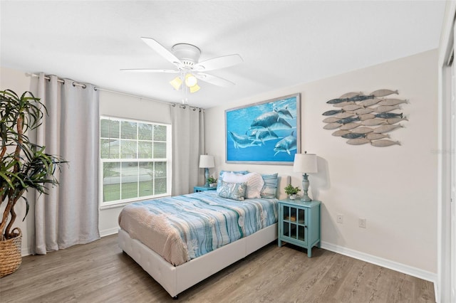 217 Birchwood Dr, Palm Coast, FL 32137 - bedroom with light wood-style floors, baseboards, and a ceiling fan