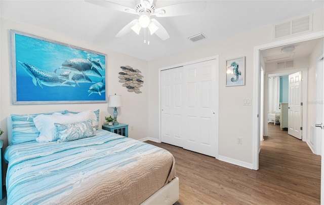 217 Birchwood Dr, Palm Coast, FL 32137 - bedroom featuring baseboards, wood finished floors, a closet, and a ceiling fan