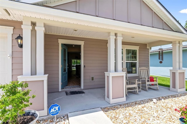 65 Lob Wedge Ln, Bunnell, FL 32110 - view of exterior entry featuring a porch and board and batten siding