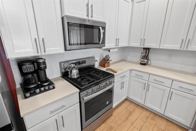 65 Lob Wedge Ln, Bunnell, FL 32110 - kitchen with appliances with stainless steel finishes, white cabinets, light countertops, and backsplash
