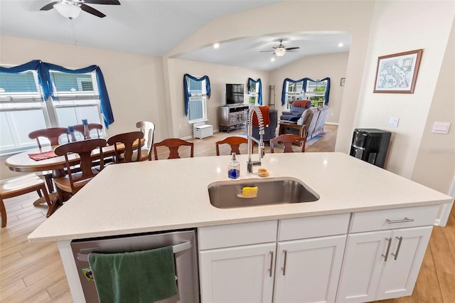 65 Lob Wedge Ln, Bunnell, FL 32110 - kitchen with ceiling fan, dishwasher, vaulted ceiling, a sink, and light wood-type flooring